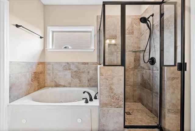 a bathroom with a bathtub and a shower
