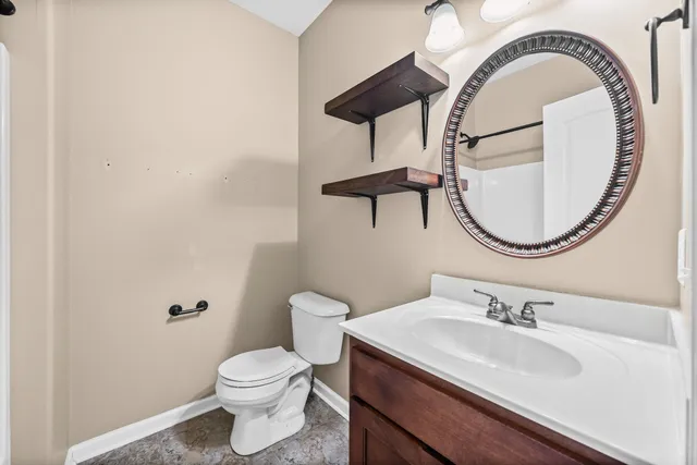 a bathroom with a sink a mirror and a toilet