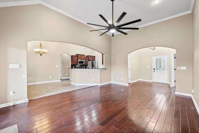 a view of a room with wooden floor and white walls