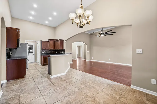 a kitchen with stainless steel appliances granite countertop a refrigerator and a stove top oven