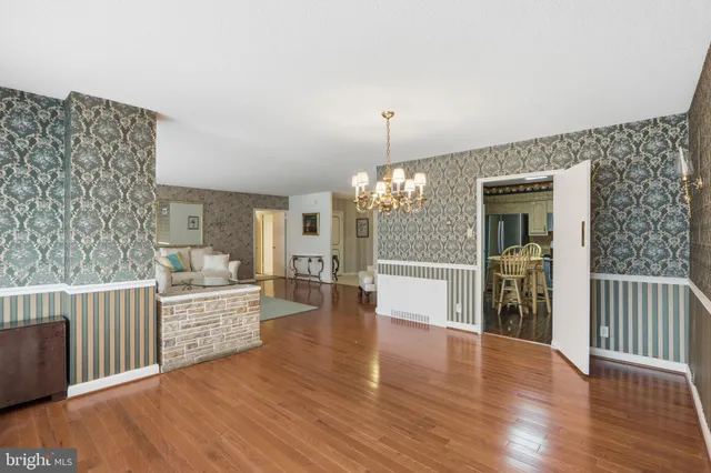 a view of a dining room with furniture wooden floor and chandelier
