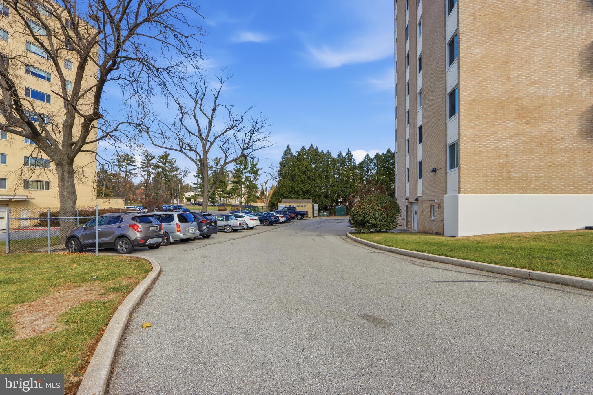 7111 Park Heights Avenue, Unit 104 Baltimore, MD 21215 - Photo 2 of 39 a view of a street with cars parked