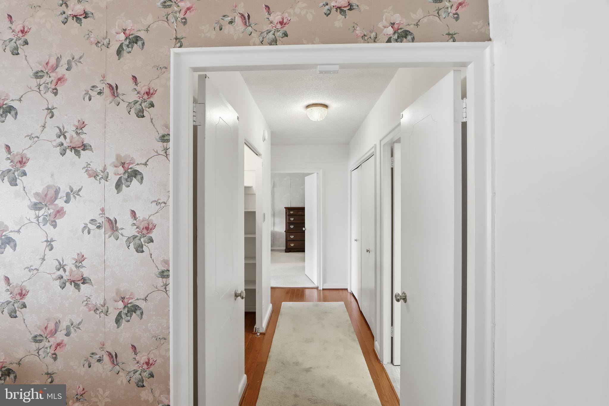 7111 Park Heights Avenue, Unit 104 Baltimore, MD 21215 - Photo 23 of 39 a view of a hallway with wooden floor and entryway