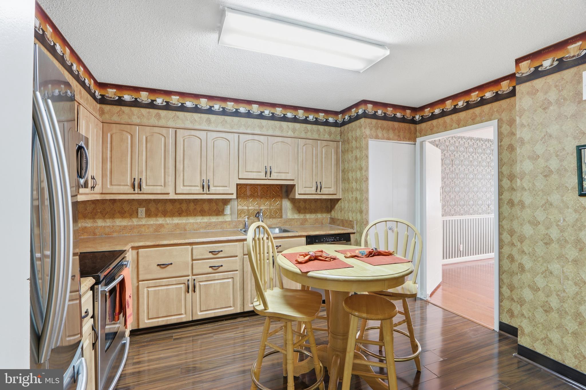 7111 Park Heights Avenue, Unit 104 Baltimore, MD 21215 - Photo 24 of 39 a kitchen with a appliances cabinets and a table