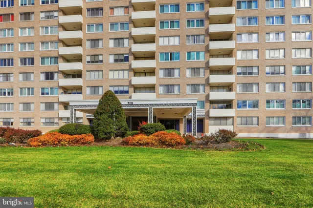 a front view of building with outdoor seating and yard