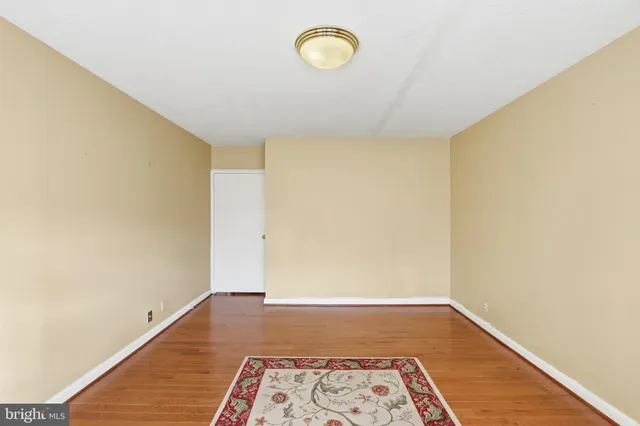 a view of a room with wooden floor and window