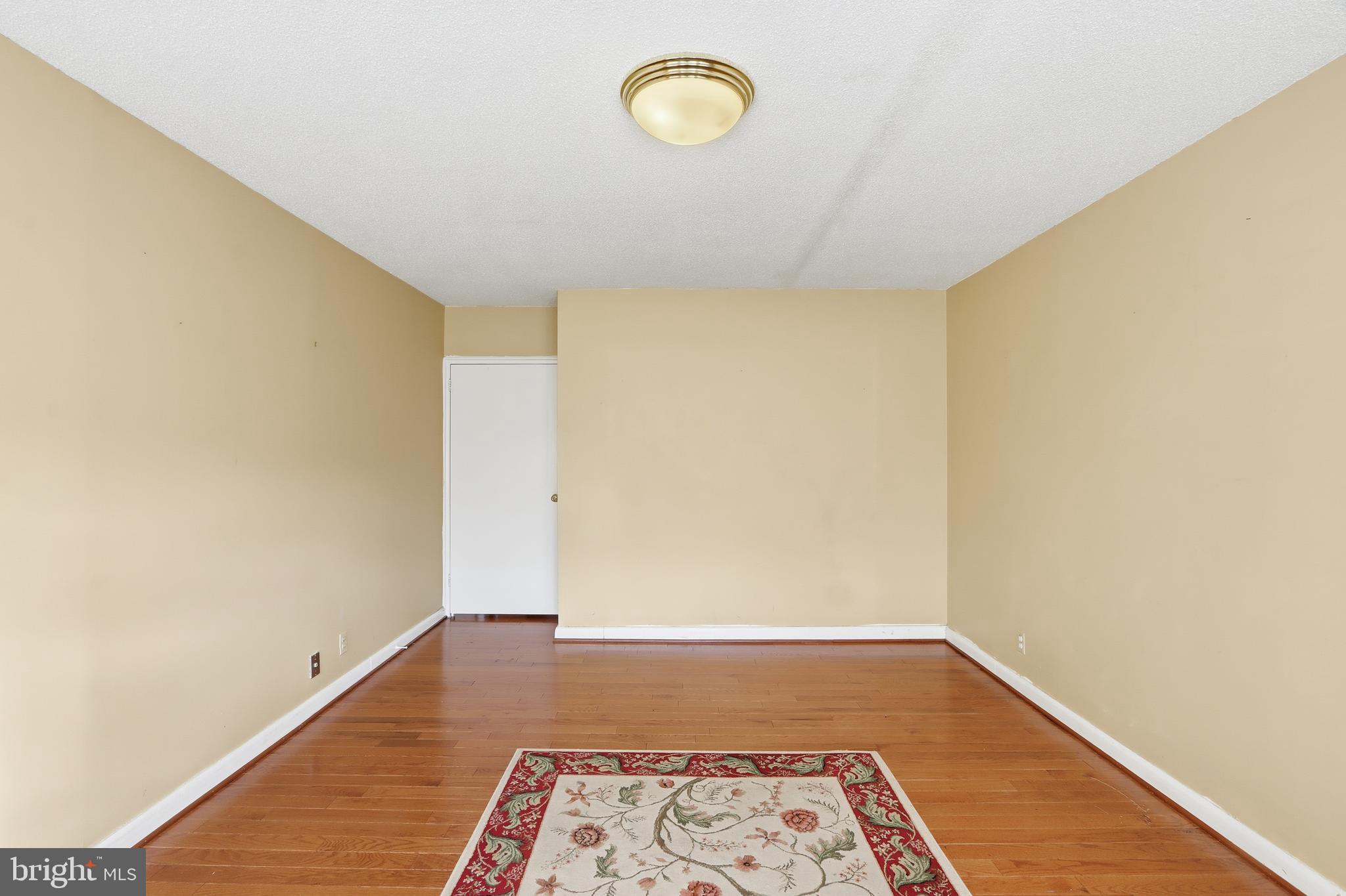 7111 Park Heights Avenue, Unit 104 Baltimore, MD 21215 - Photo 32 of 39 a view of a room with wooden floor and window