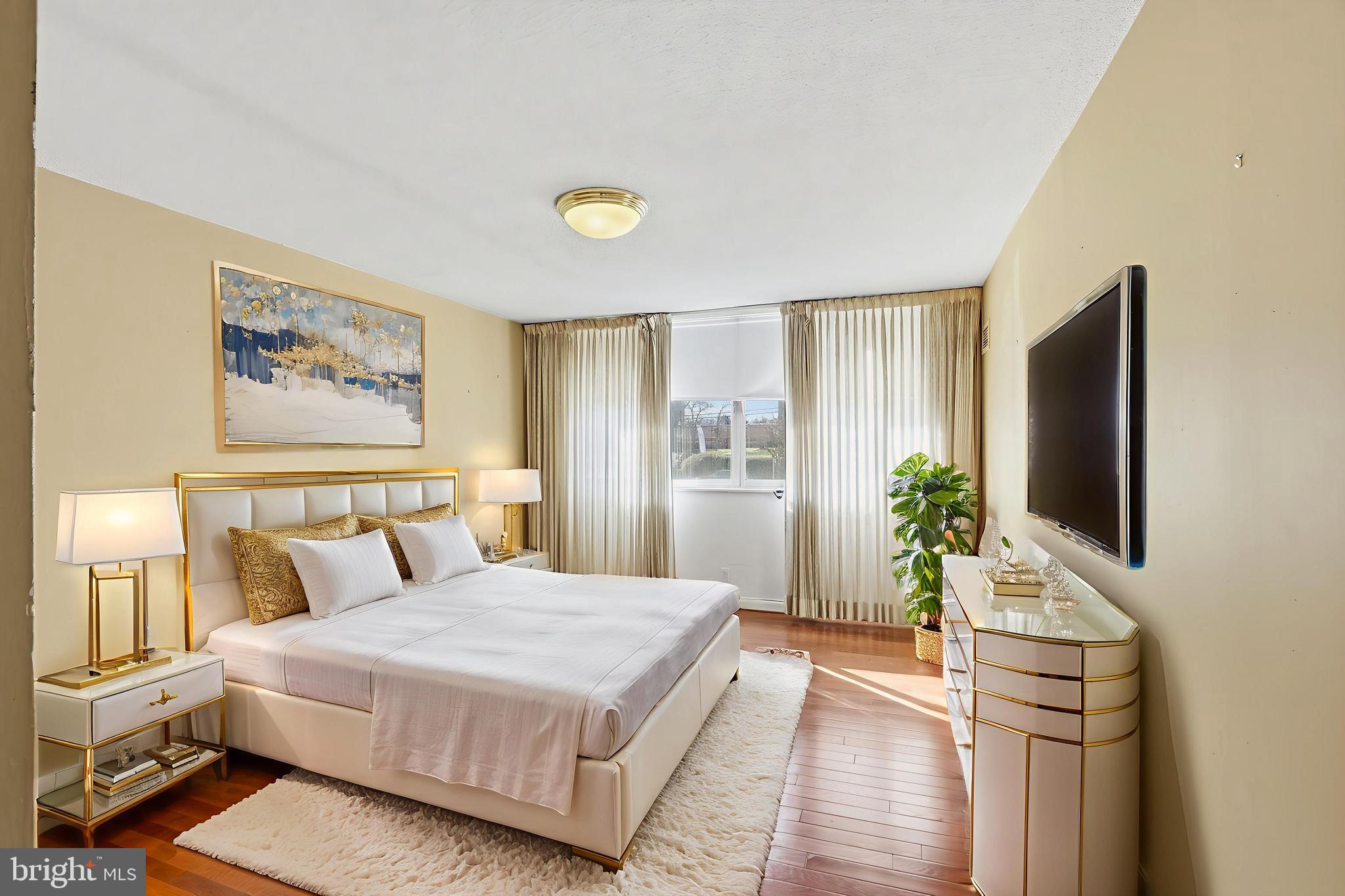 7111 Park Heights Avenue, Unit 104 Baltimore, MD 21215 - Photo 35 of 39 a bedroom with a bed and a flat screen tv