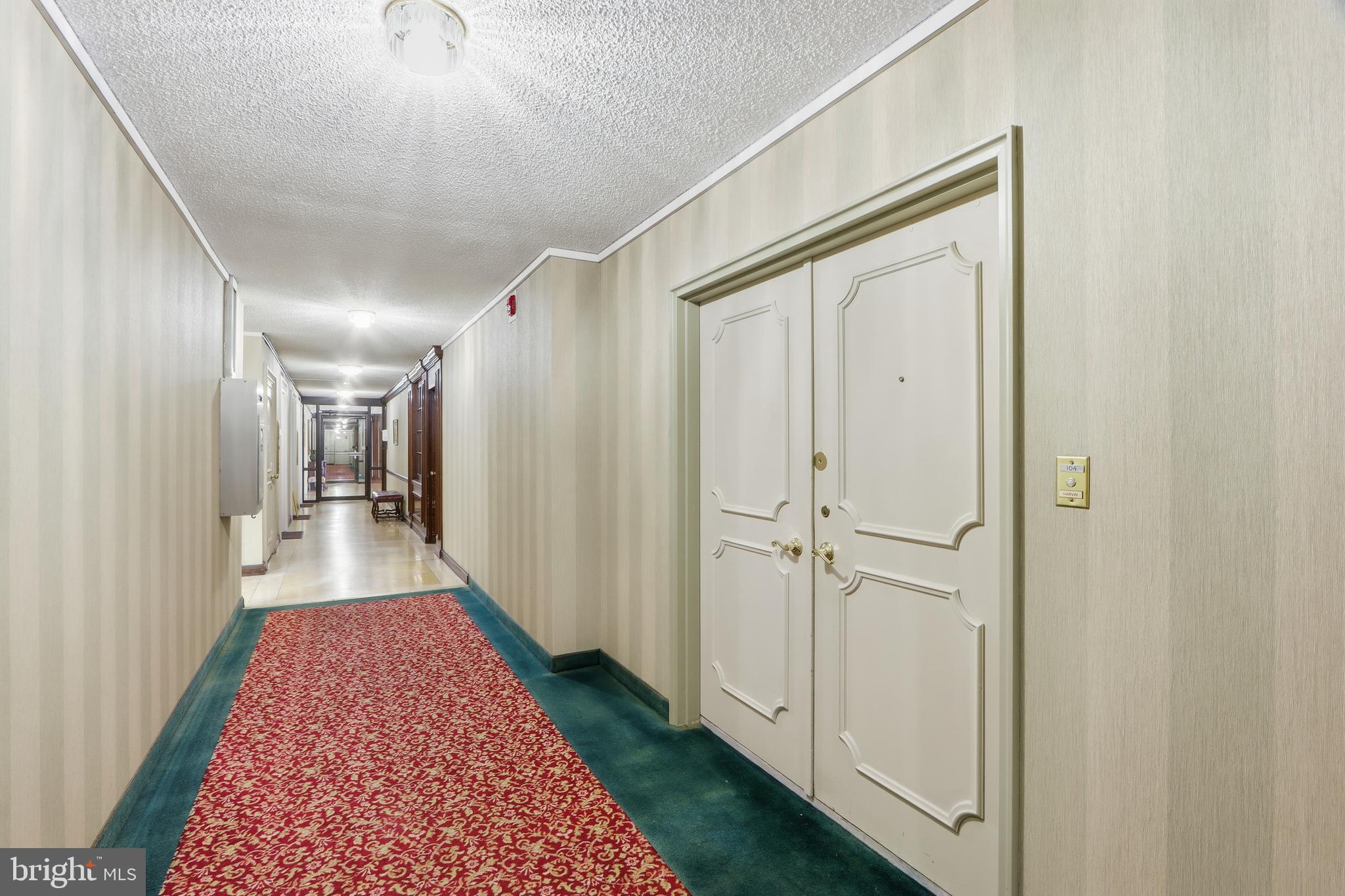 7111 Park Heights Avenue, Unit 104 Baltimore, MD 21215 - Photo 10 of 39 a view of a hallway with a white walls