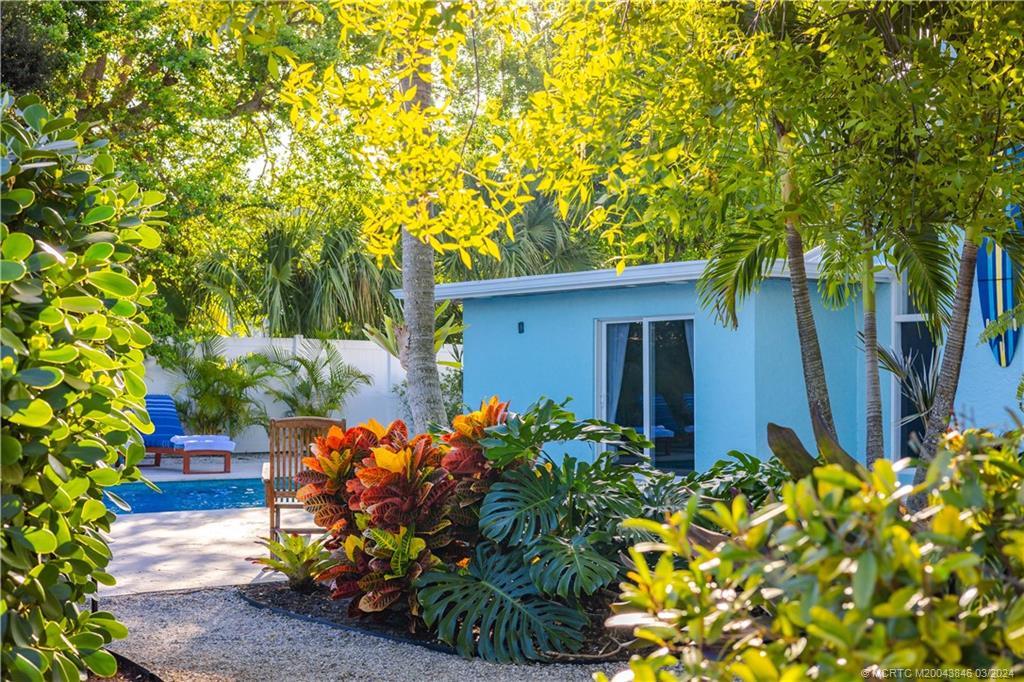 3713 Southeast Matanzas Street Stuart, FL 34996 - Photo 11 of 53 a front view of a house with a lot of flower plants