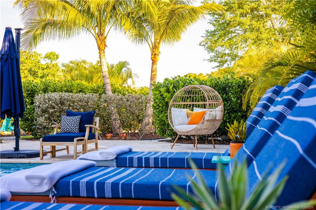 3713 Southeast Matanzas Street Stuart, FL 34996 - Photo 16 of 53 a view of a swimming pool with a patio and a garden