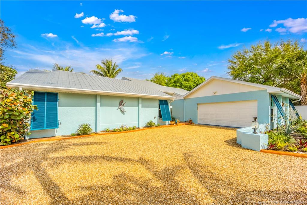 3713 Southeast Matanzas Street Stuart, FL 34996 - Photo 2 of 53 a view of a house with a yard and potted plants