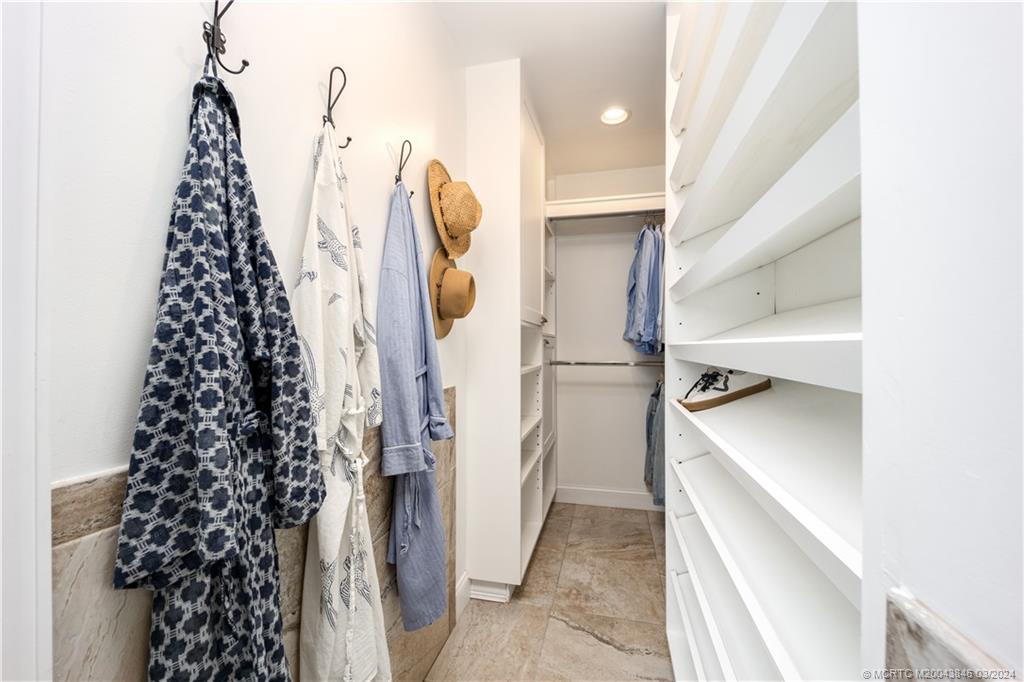 3713 Southeast Matanzas Street Stuart, FL 34996 - Photo 30 of 53 a view of walk in closet with clothes and shoes