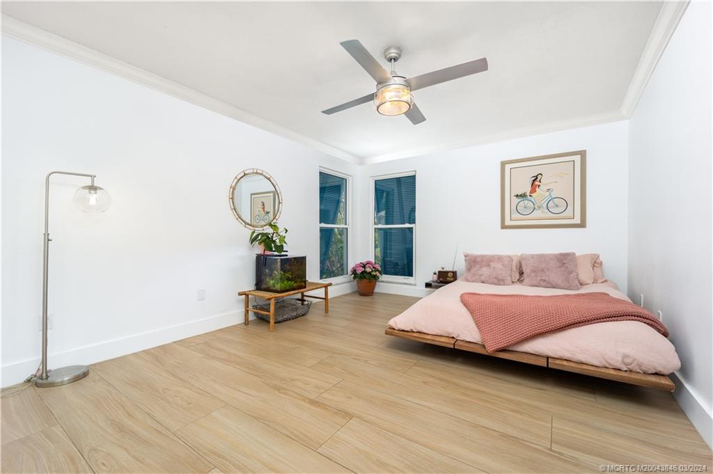 3713 Southeast Matanzas Street Stuart, FL 34996 - Photo 31 of 53 a bedroom with a bed and wooden floor