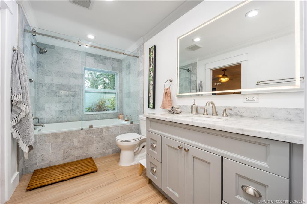 3713 Southeast Matanzas Street Stuart, FL 34996 - Photo 32 of 53 a bathroom with a granite countertop sink toilet and shower
