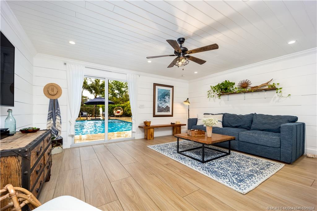 3713 Southeast Matanzas Street Stuart, FL 34996 - Photo 33 of 53 a living room with furniture and a flat screen tv