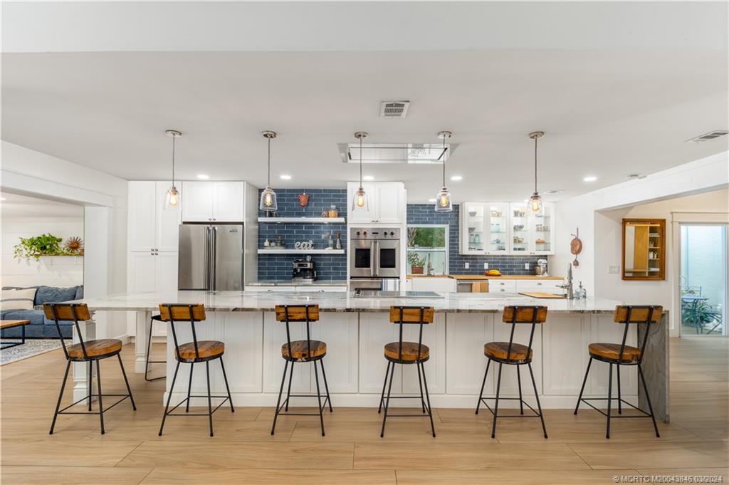 3713 Southeast Matanzas Street Stuart, FL 34996 - Photo 4 of 53 a kitchen with appliances and chairs in it