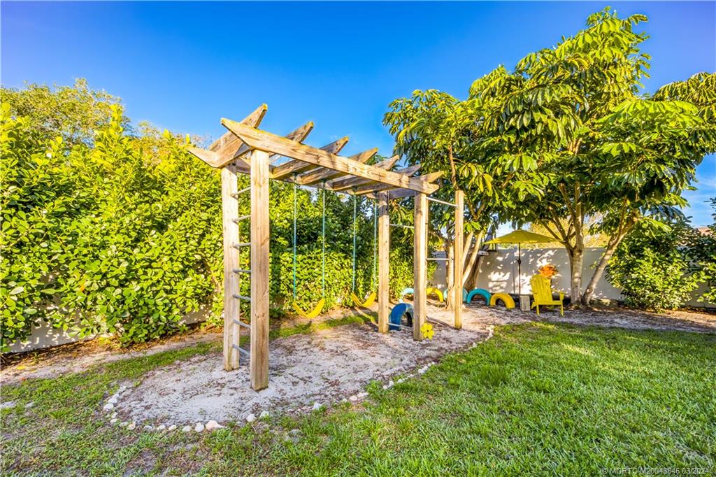 3713 Southeast Matanzas Street Stuart, FL 34996 - Photo 46 of 53 a view of a park with swings and slides