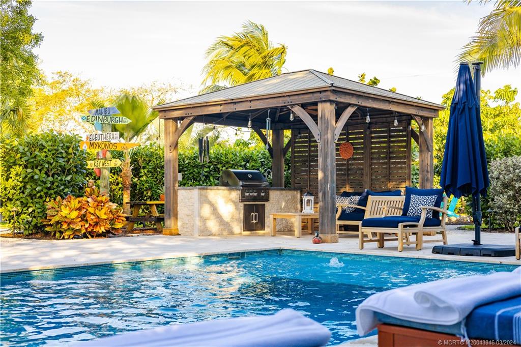3713 Southeast Matanzas Street Stuart, FL 34996 - Photo 8 of 53 a view of a house with backyard porch and sitting area
