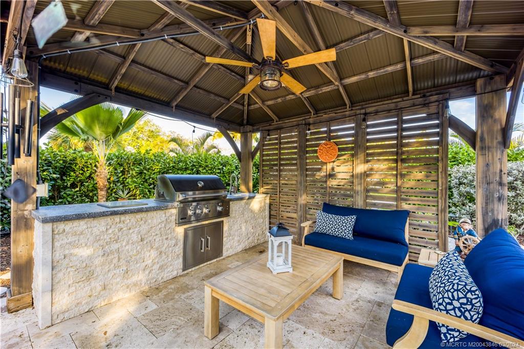 3713 Southeast Matanzas Street Stuart, FL 34996 - Photo 10 of 53 a patio with yard glass top table and chairs