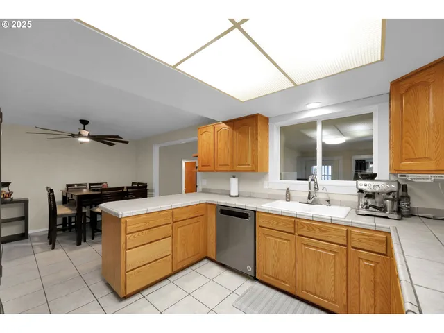 a kitchen with a sink a stove and cabinets