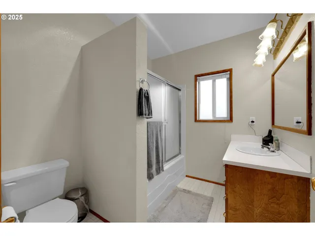 a bathroom with a sink toilet and mirror