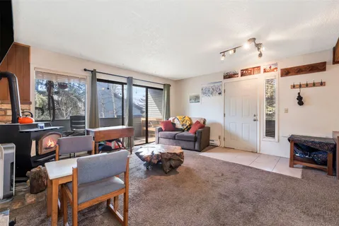 a living room with furniture and a floor to ceiling window
