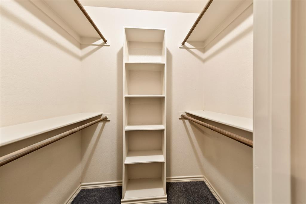 2105 Ridgewood Drive Bridgeport, TX 76426 - Photo 22 of 27 Built-in closet system featuring shelving, hanging rods, and dark carpeting