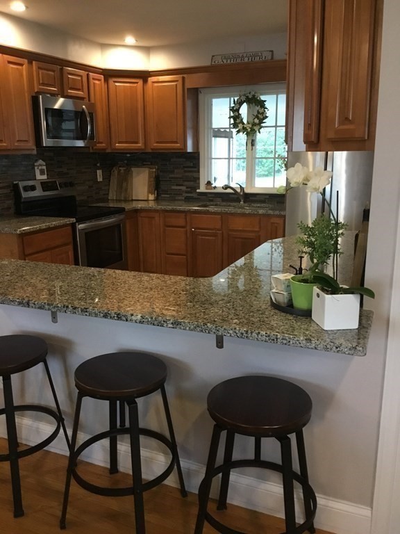 94 Winthrop Street Fall River, MA 02721 - Photo 9 of 29 a kitchen with stainless steel appliances granite countertop sink stove top oven and microwave