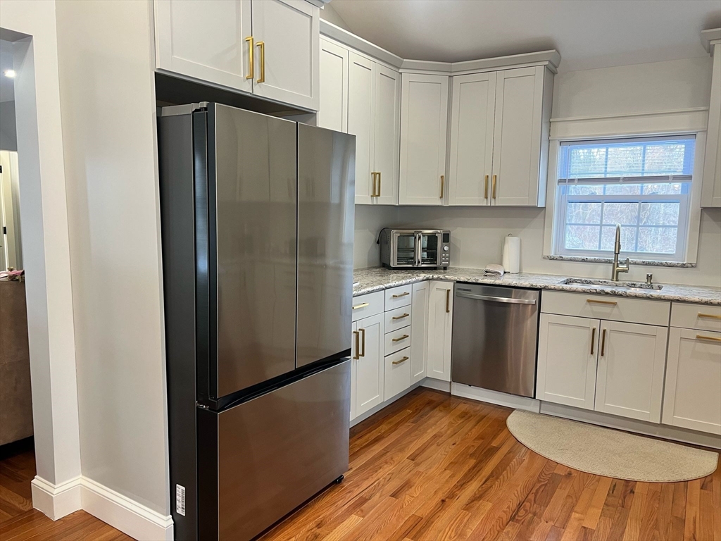 81 Stuart Street Gardner, MA 01440 - Photo 5 of 24 a kitchen with a refrigerator sink and cabinets