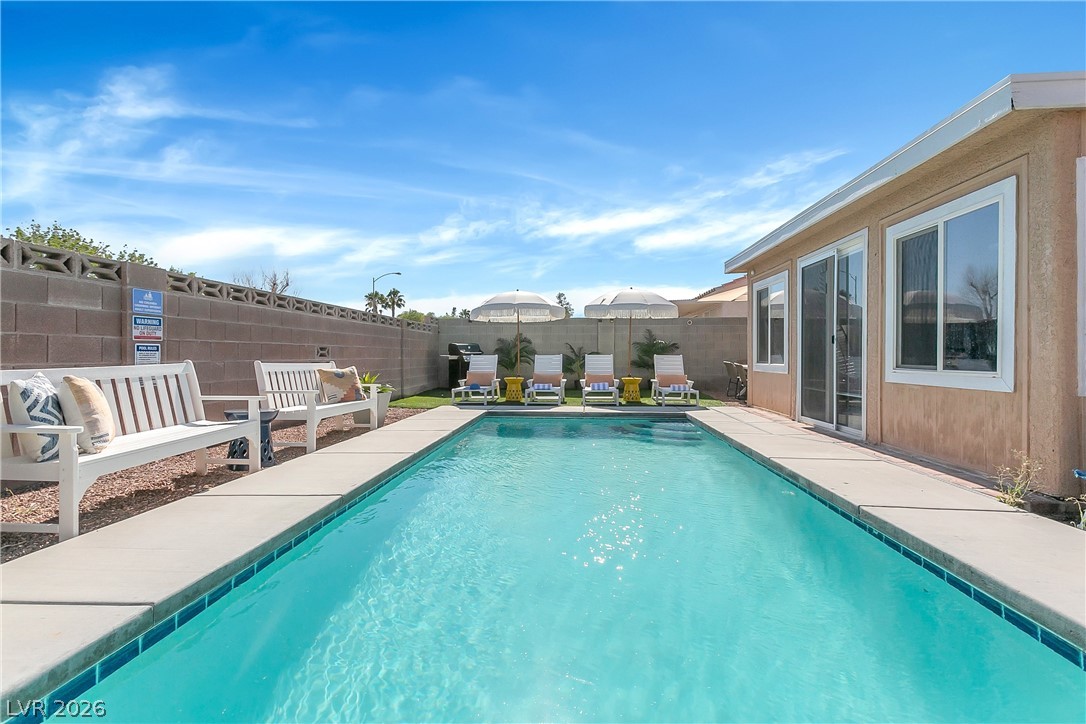 101 Beaver Ridge Avenue North Las Vegas, NV 89031 - Photo 31 of 42 An inviting private pool and lounge area, ideal for relaxation under the sun.