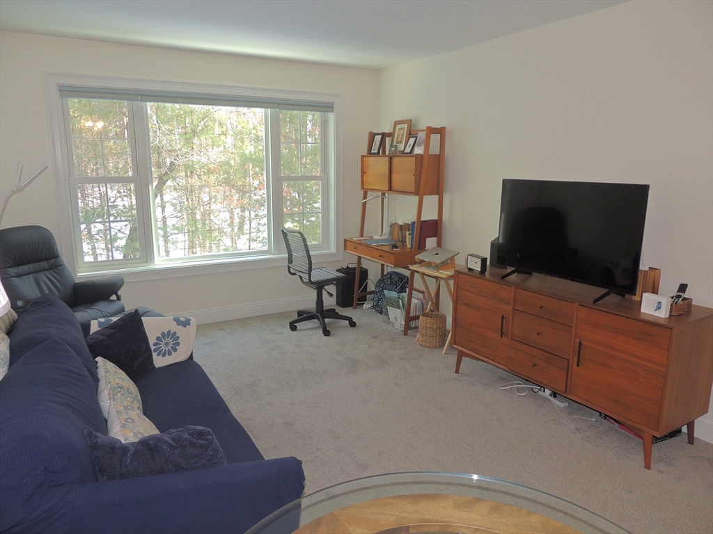 26 Greenleaves Drive, Unit 635 Amherst, MA 01002 - Photo 2 of 11 a living room with furniture and a flat screen tv