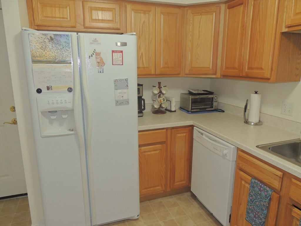 26 Greenleaves Drive, Unit 635 Amherst, MA 01002 - Photo 6 of 11 a kitchen with refrigerator and cabinets