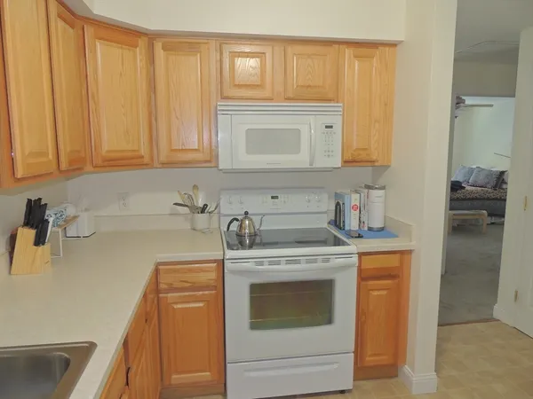 a kitchen with a stove top oven and sink