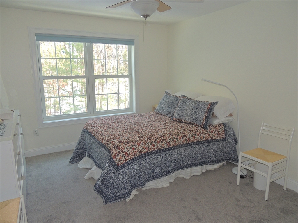 26 Greenleaves Drive, Unit 635 Amherst, MA 01002 - Photo 8 of 11 a bedroom with a bed and a window