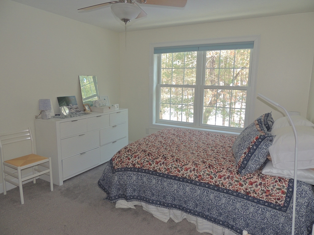26 Greenleaves Drive, Unit 635 Amherst, MA 01002 - Photo 9 of 11 a spacious bedroom with a bed and a window