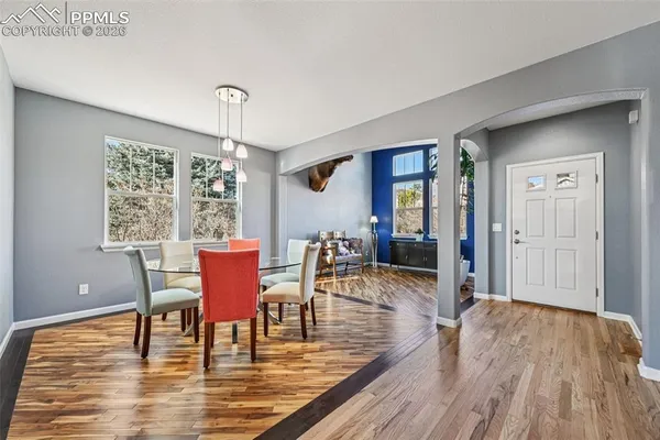 a view of a dining room with furniture window and wooden floor