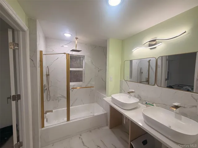 a bathroom with a double vanity sink mirror double and bathtub