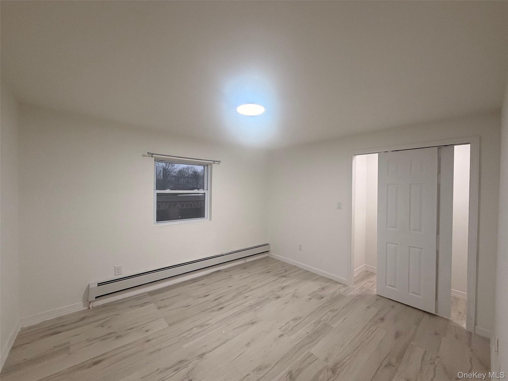 79 Monhagen Avenue Middletown, NY 10940 - Photo 17 of 22 an empty room with wooden floor and windows