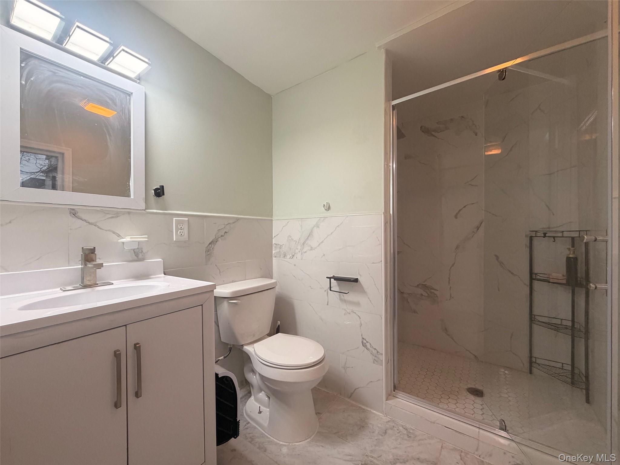 79 Monhagen Avenue Middletown, NY 10940 - Photo 19 of 22 a bathroom with a toilet sink a shower and