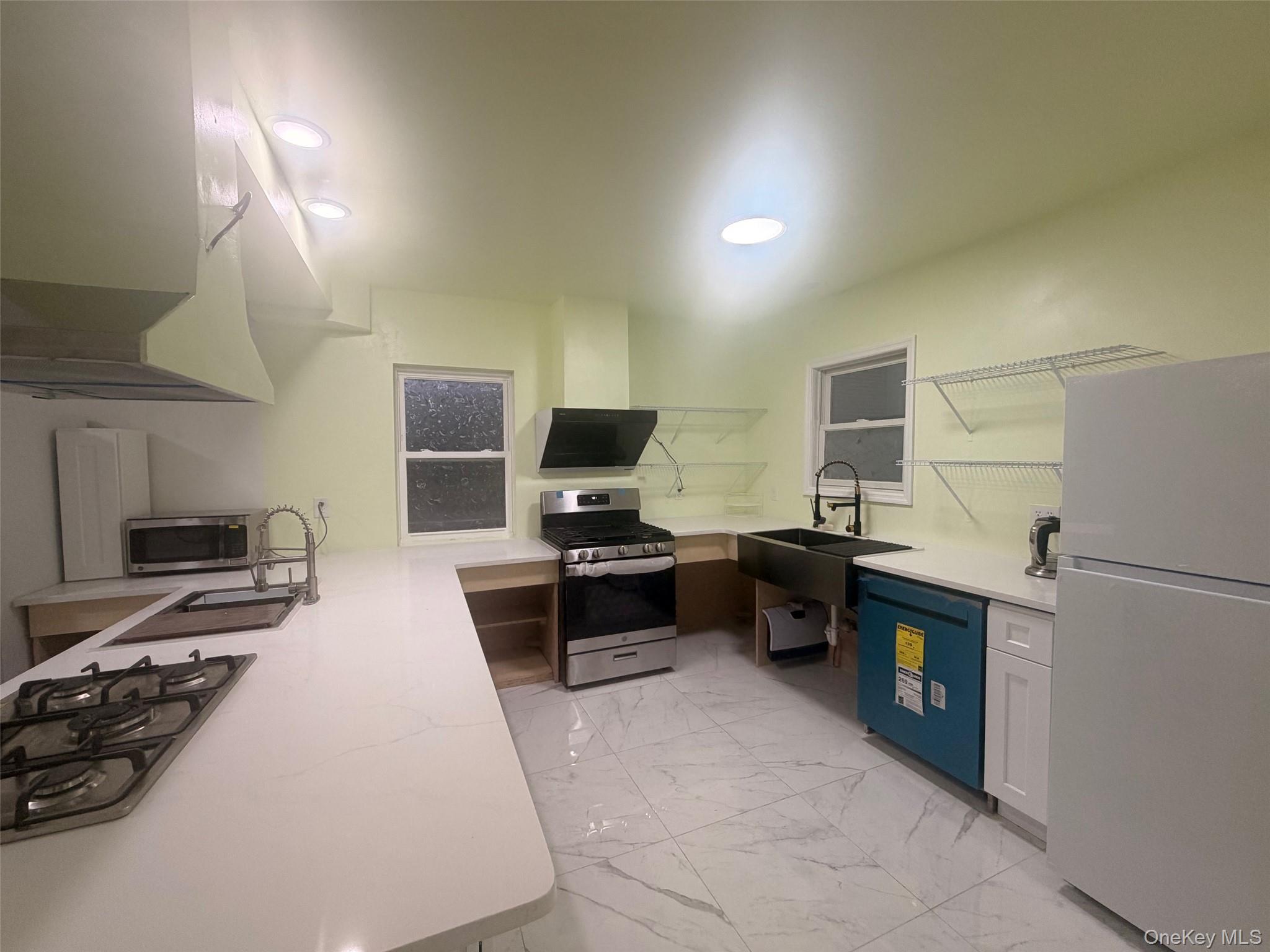 79 Monhagen Avenue Middletown, NY 10940 - Photo 7 of 22 a kitchen with a refrigerator a stove a sink and a refrigerator