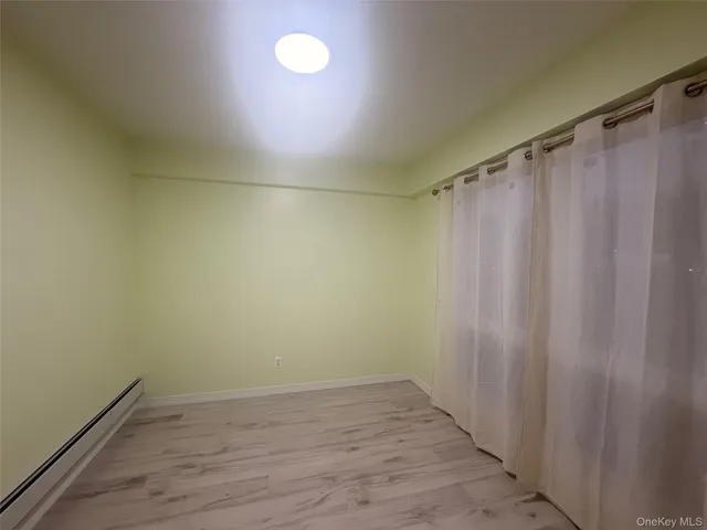 a view of a room with wooden floor and fan