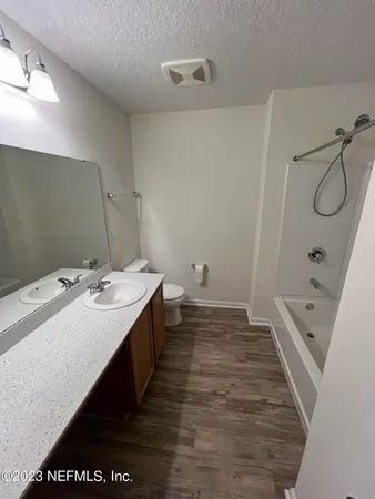 a bathroom with a double vanity sink and mirror