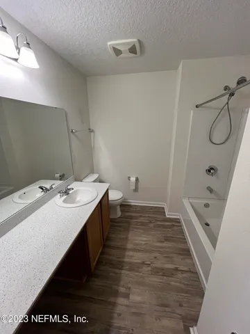 a bathroom with a double vanity sink and mirror