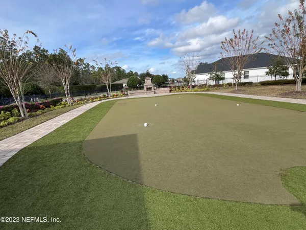 a view of a swimming pool and a yard