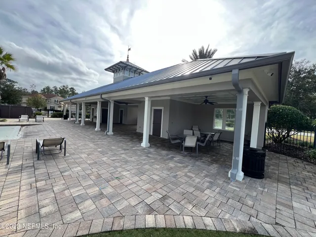 a view of a house with backyard porch and sitting area