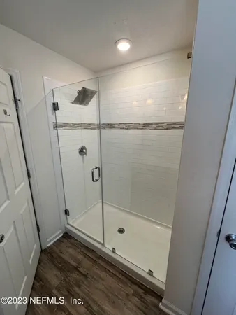 a bathroom with a glass shower door