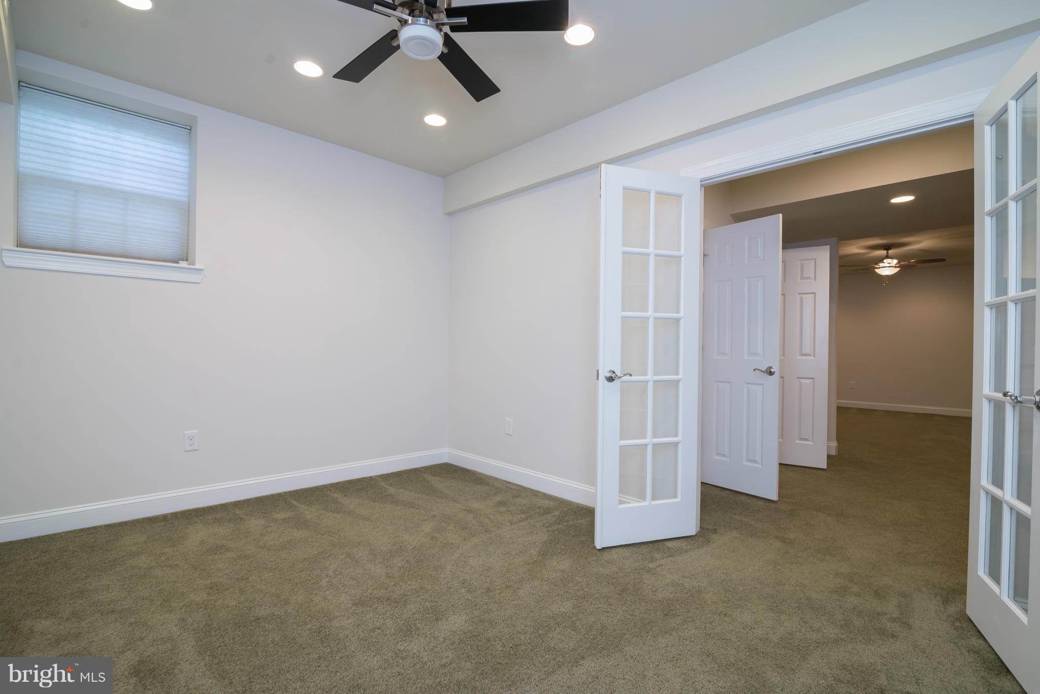 831 Woodside Parkway Silver Spring, MD 20910 - Photo 27 of 30 an empty room with a empty space and a ceiling fan