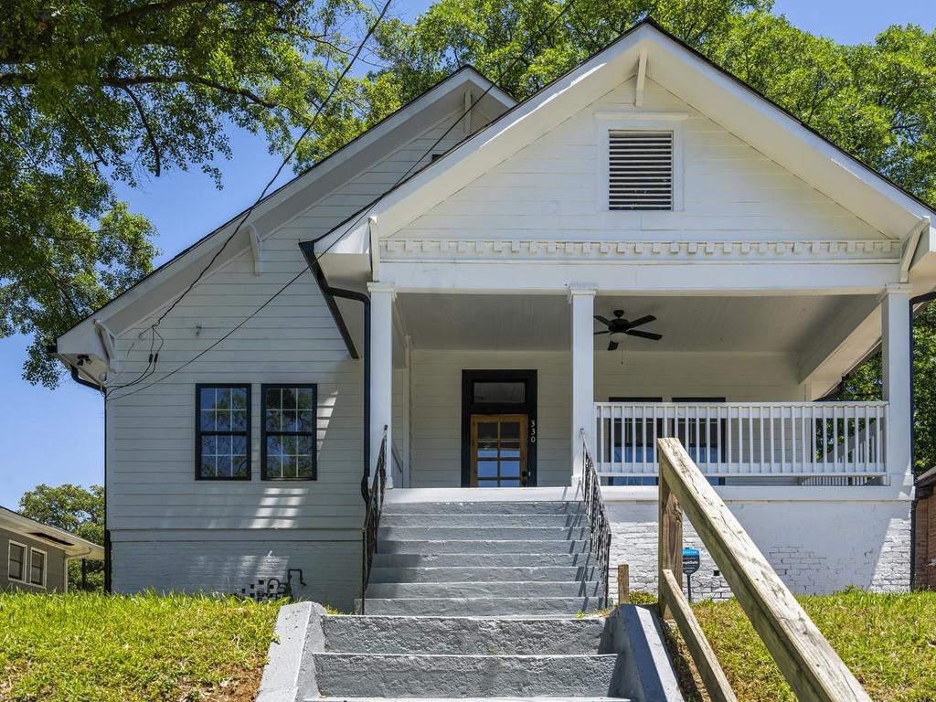 330 Wellington Street Southwest Atlanta, GA 30310 - Photo 1 of 1 a front view of house along with deck and outdoor seating