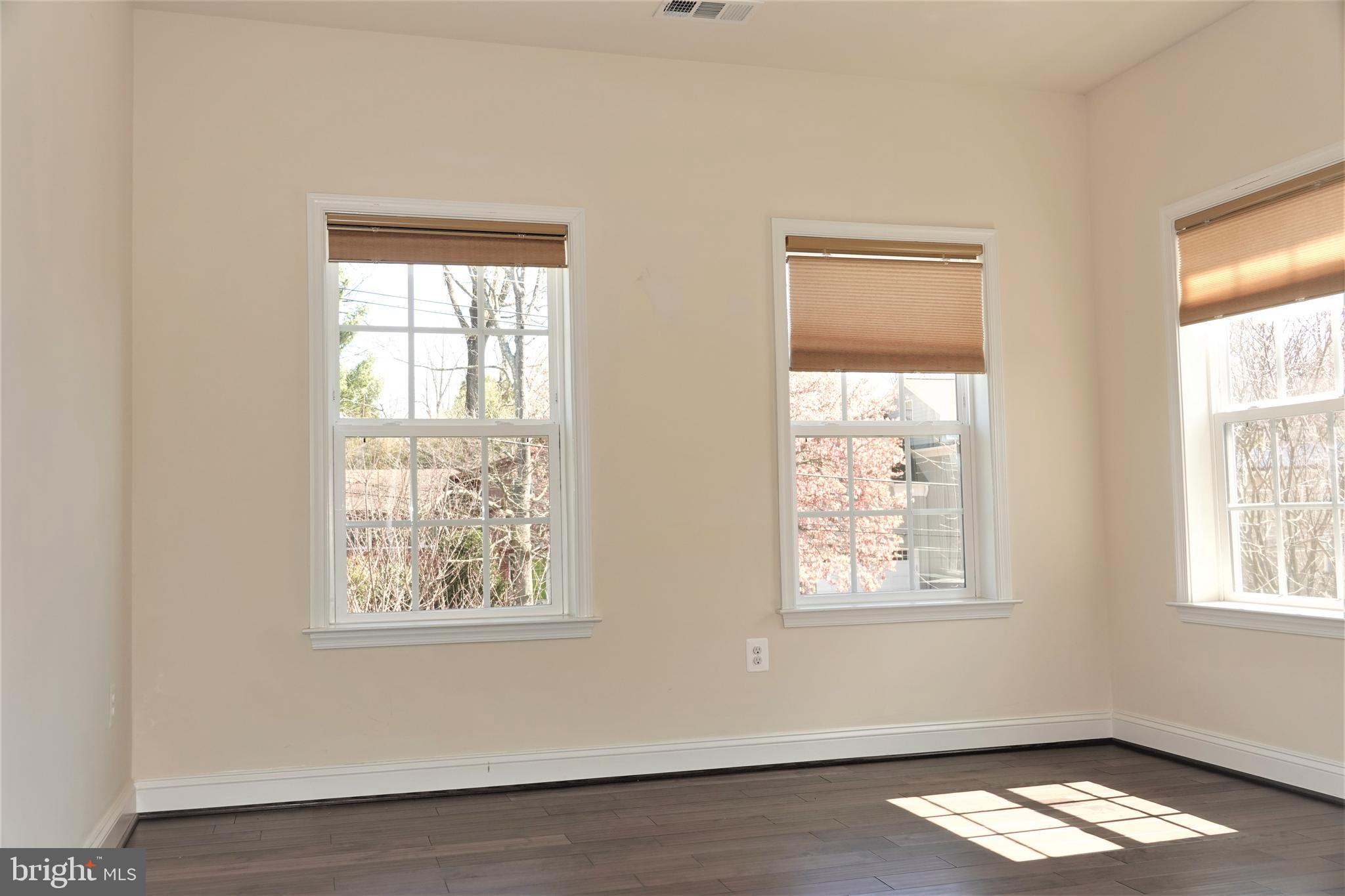 6606 Pyle Road Bethesda, MD 20817 - Photo 18 of 29 a view of empty room with wooden floor and windows